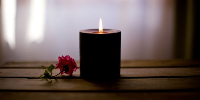 candle-on-a-table-with-a-rose-royalty-free-image-1582562759